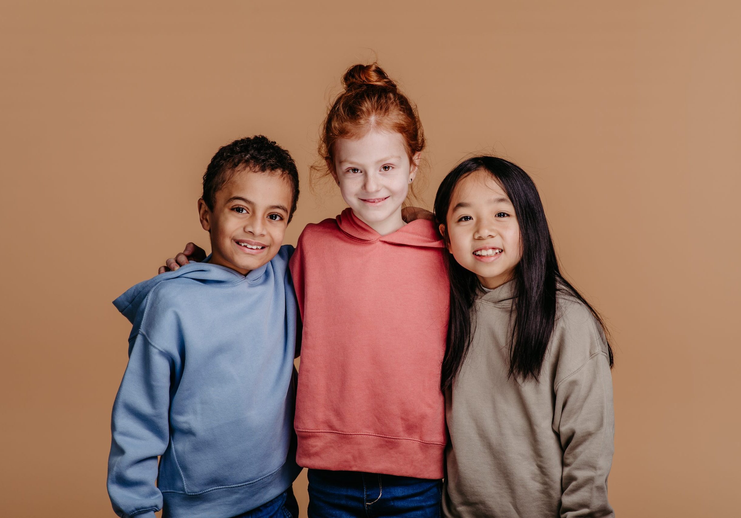 Portrait of three children, studio shoot. Concept of diversity in a friendship.