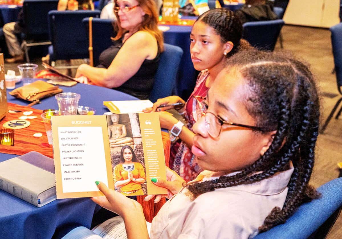 Young African American girl holding a booklet.